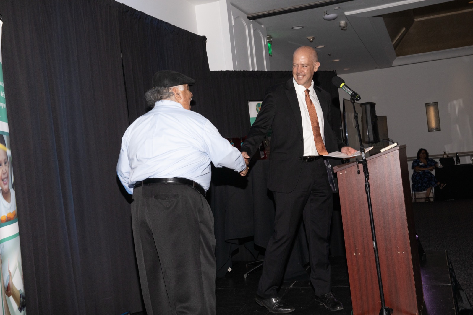 A congratulatory handshake at the podium
