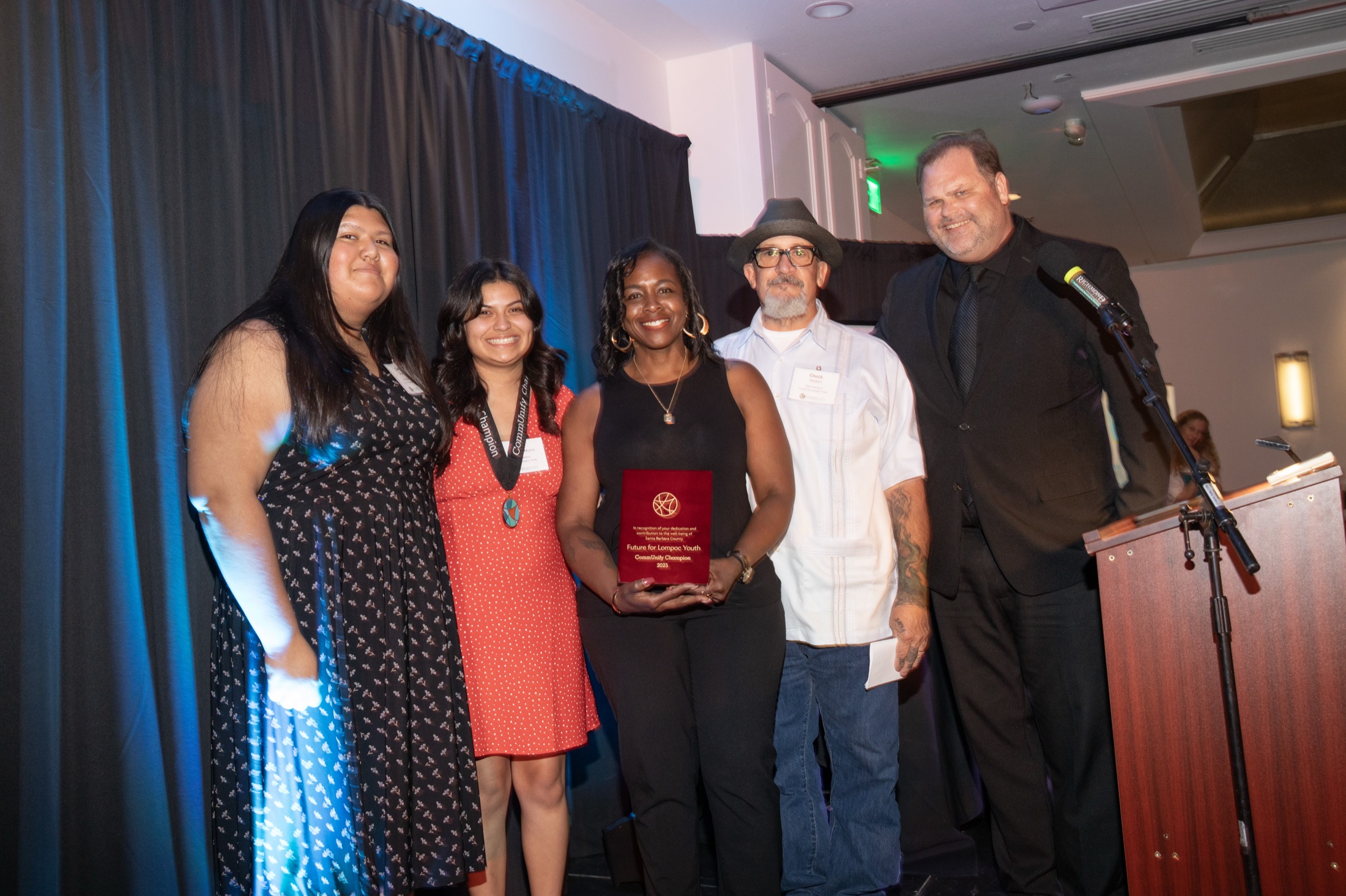 Honorees accepting a CommUnify Champion award on stage